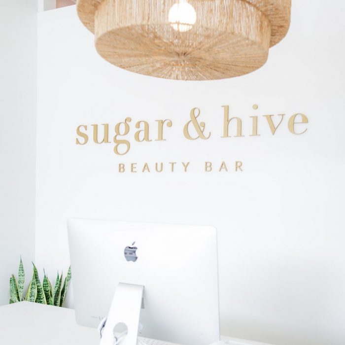 Sugar & Hive Beauty Bar logo design in gold and white